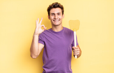 feeling happy, relaxed and satisfied, showing approval with okay gesture, smiling. kill flies...