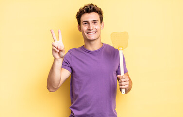 smiling and looking happy, carefree and positive, gesturing victory or peace with one hand. kill...