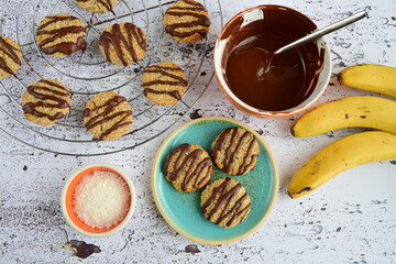 Banana coconut cookies drizzled with melted chocolate