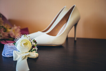 preparation for the wedding. wedding day. bouquet for the bride and her shoes.