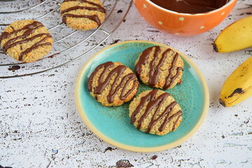 Banana coconut cookies drizzled with melted chocolate