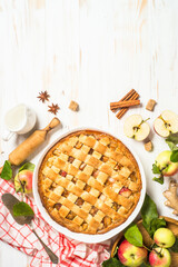 Apple pie. Traditional apple cake with ginger and cinnamon at white wooden table. Top view image with copy space.