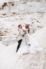 Beautiful wedding couple bride and groom at wedding day outdoors at ocean beach. Happy marriage couple o