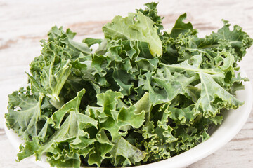 Fresh healthy green curly kale, diet, slimming and healthy eating concept