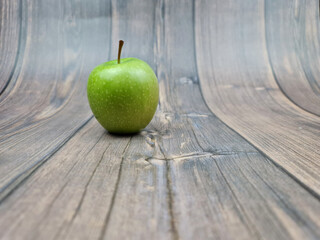 The Natural Green apple on a wooden background close-up.