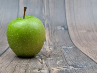 The Natural Green apple on a wooden background close-up.