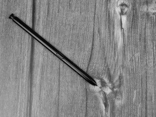The Black stylus from a mobile device. Digital stylus close-up.