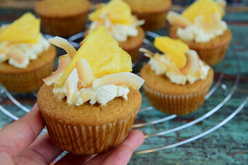 Pineapple coconut cupcakes on cooling rack. Selective focus