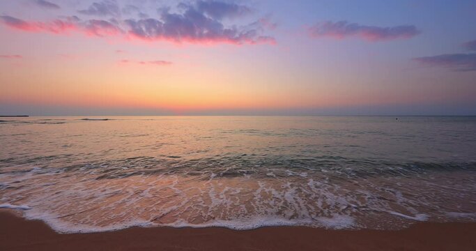 Ocean beach sunrise or sunset. Waving sea waves, 4k video