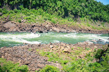 Rushing river surrounded by rocks on the shore