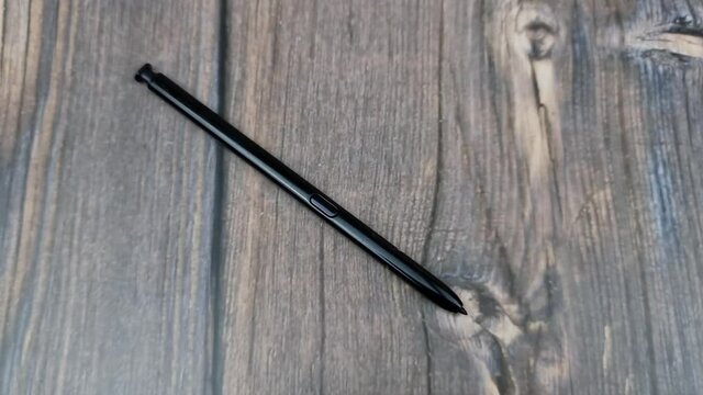 The Black stylus from a mobile device. Digital stylus close-up.