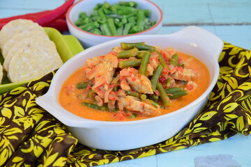 Sayur tempe buncis. Tempeh and green bean cooked in spices and coconut milk. Indonesian food. Served with rice