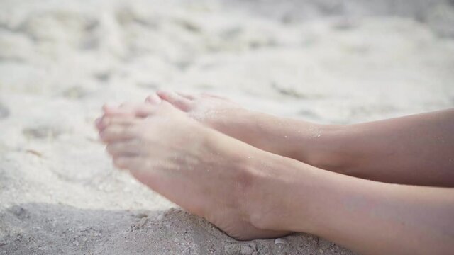 Hallux valgus on female legs close up beach sand. Foot joint deformity. Health care and medicine problem with human body. Vacation Traveling Halluxvalgus