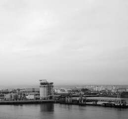 Fototapeta na wymiar Coastal industrial district buildings skyline with moody sky at Hakodate port in Hokkaido, Japan