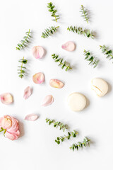 woman table design with flower and macaroons in soft light top view