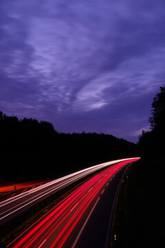 Long exposure of a motorway with light trails during blue hour near Overath, Germany