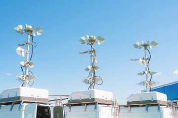 Three powerful mobile antennas on the roofs of a van car for communication or location observation...