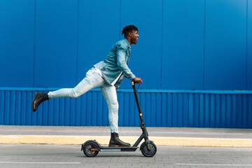 modern african american on electric scooter, business man is one to work, student is one to study