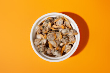 top view plated cockles cap with orange background