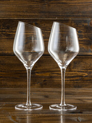 wine glasses with beveled edges on dark wooden background
