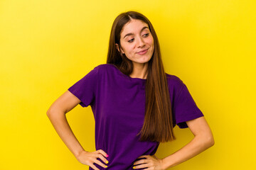 Young caucasian woman isolated on yellow background dreaming of achieving goals and purposes