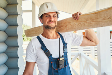 Adult man with board looking into camera