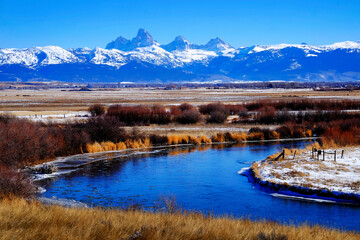Grand Teton Mountain Range with Curving River Snow and Sky