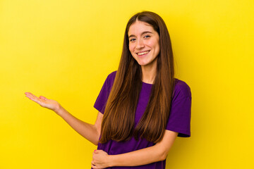 Young caucasian woman isolated on yellow background showing a welcome expression.