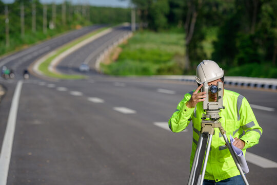 Pictures of civil engineers doing survey work The theodolite was used to measure the land coordinates. Standing at an outdoor theodolite at a construction site on the road.
