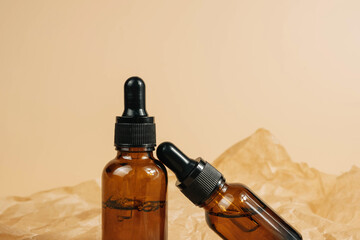 Mock-up of a set of empty cosmetic containers with pipettes made of amber glass on a beige...