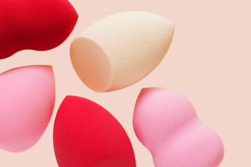 Bright cosmetic beauty sponges different form Red and pink colored makeup tools for tone cream,...