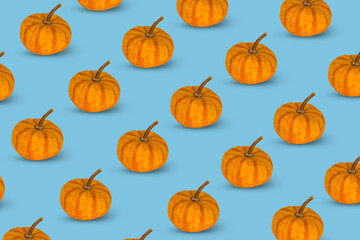 Colorful pattern of orange pumpkins on a blue background.