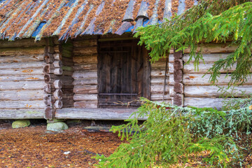 Fototapeta na wymiar Idyllic old log cabin in a forest
