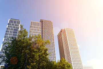 Homes of luxury housing apartments against a blue sky in sunlight. Housing, business, real estate concept.