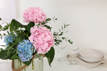 Beautiful hortensia flowers in kitchen. Space for text