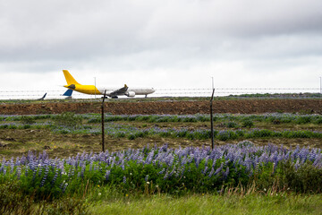 Cargo airplane at the beginning of a runway and ready to take off on a cloudy summer day. A taxiing...