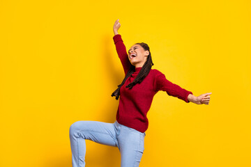 Photo of funny cute dark skin woman dressed red sweater dancing smiling isolated yellow color background
