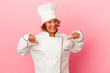 Middle age latin woman isolated on pink background feels proud and self confident, example to follow.