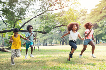 Happy kids running in the park in summer.