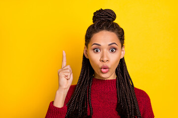 Photo of confident shocked dark skin woman dressed red sweater pointing finger empty space isolated yellow color background