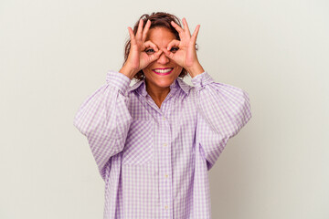 Middle age latin woman isolated on white background excited keeping ok gesture on eye.