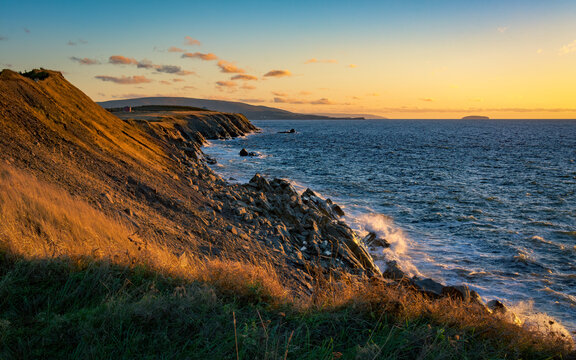 Sunset is Near - As waves crash upon the rocky shore, sunset is coming to the Atlantic coast of Cape Breton on a pleasant day in autumn.
