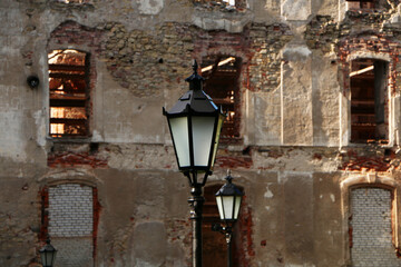 Old lantern on the background of the ancient wall.