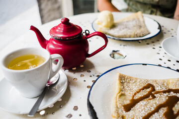 breakfast in a coffee shop with crepes and tea