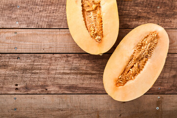Melon. Pieces of fresh melon for making fruit dessert in glass on an old wooden background. Mock up. Top view.