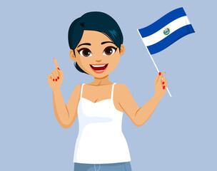 Beautiful happy smiling Salvadoran woman holding El Salvador Flag making pointing hand gesture - obrazy, fototapety, plakaty