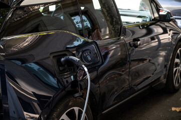 Fototapeta na wymiar Electric car charging at a charging point