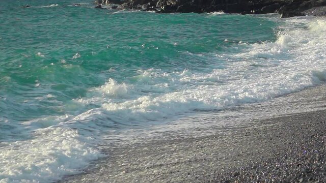 Slow motion of waves crashing onto a tropical pebble beach. Filmed at Looc Beach in Surigao Philippines.