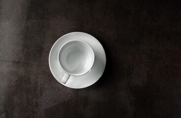 White mug and saucer for hot drinks on a neutral background