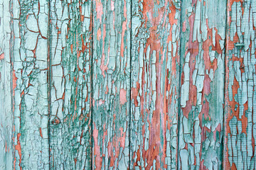 Texture of planks of old wood with peeling green paint